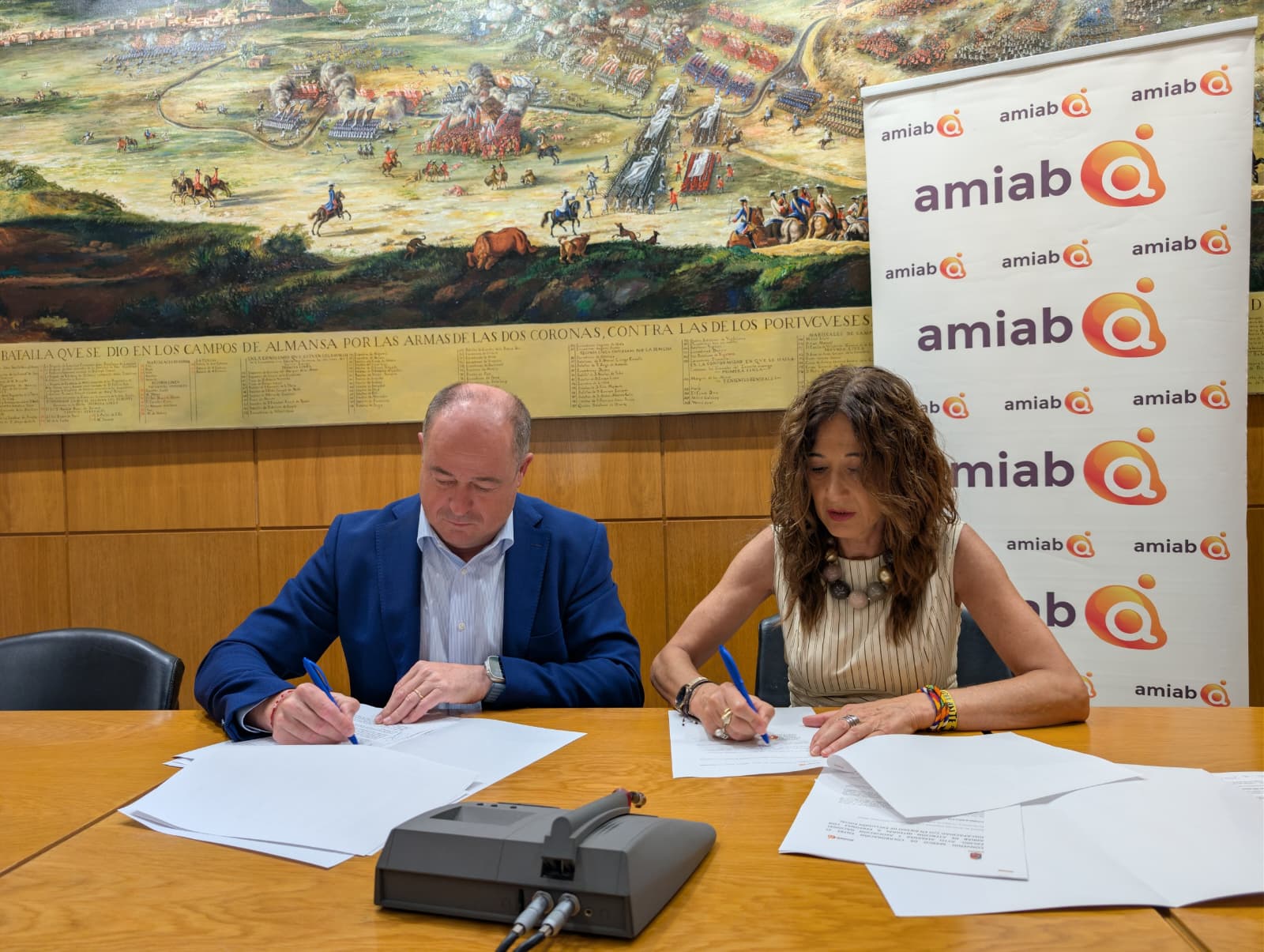 El presidente de amiab, Emilio Sáez, y la alcaldesa de Almansa, Pilar Callado, formalizando la firma del convenio de colaboración institucional en el consistorio