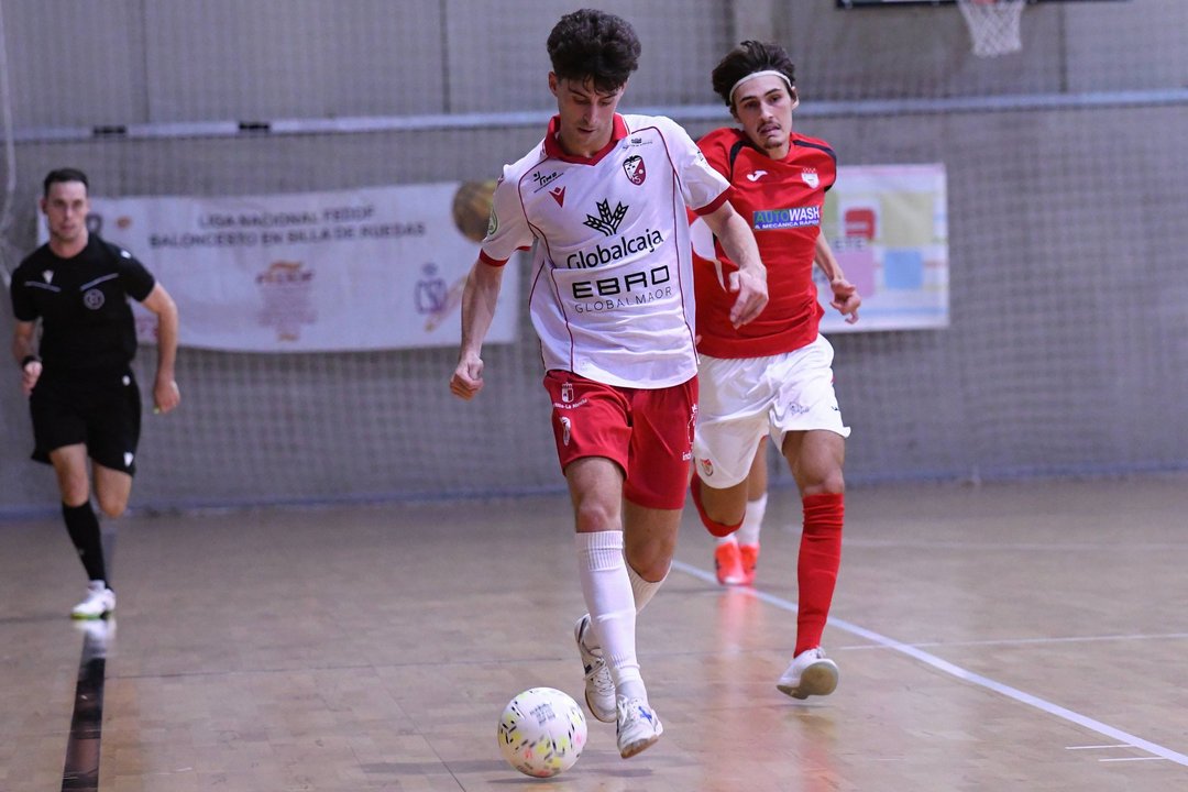 Jugadores del Albacete FS disputando un balón durante un partido en el Pabellón Universitario